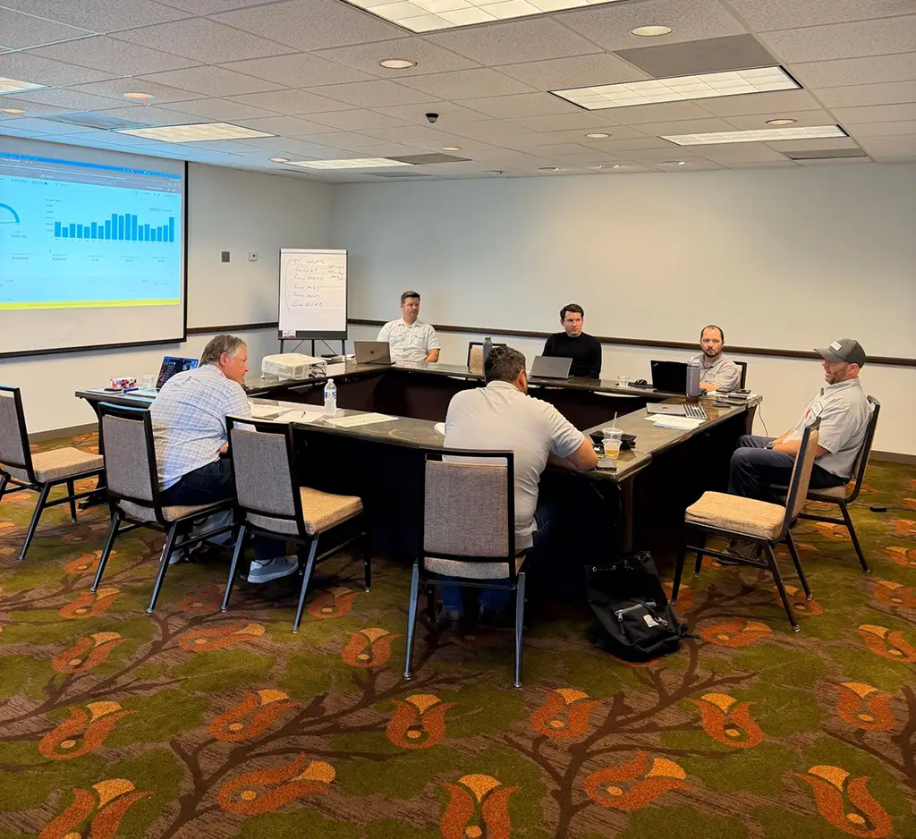 Austin Service Management Meeting 2026 Service management meeting in Austin, TX, featuring Aaron Arnett and Dani Parks from Bow River Capital. Teams collaborating around tables with data on screen.