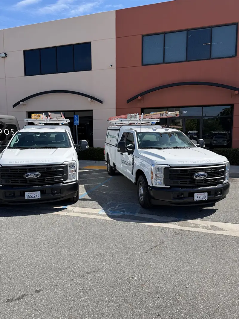 Two new Ford F-250 service trucks parked in front of the office in Northern California.